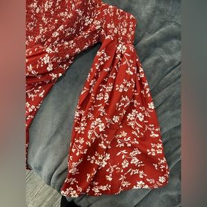 Red dress with cream flower design. Smocked top. Bell sleeve